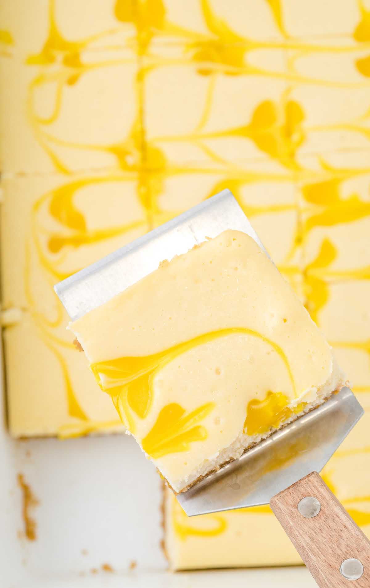 overhead shot of a lemon cheesecake bar on a spatula
