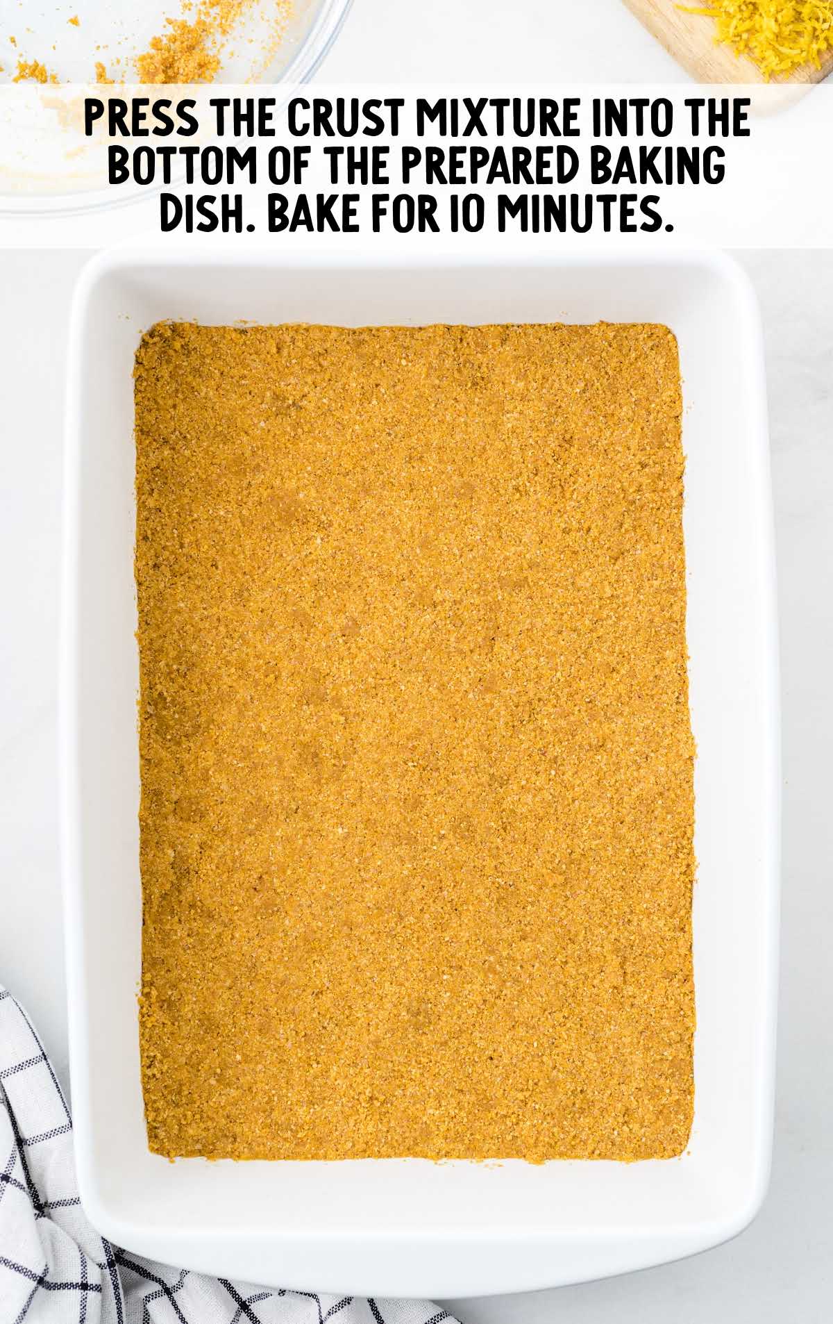 graham cracker crumb mixture spread at the bottom of a baking dish