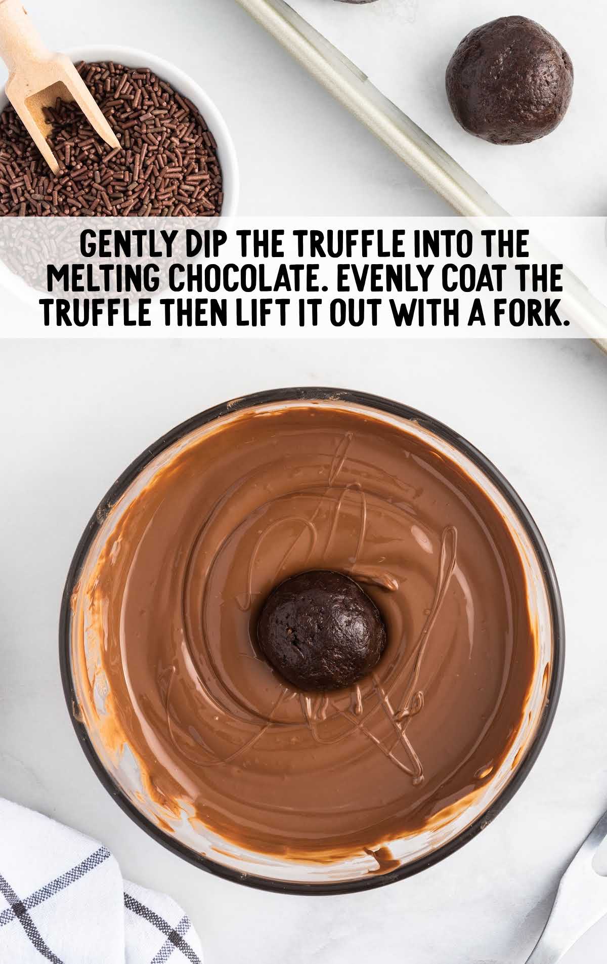 truffles dipped into a bowl of melted chocolate