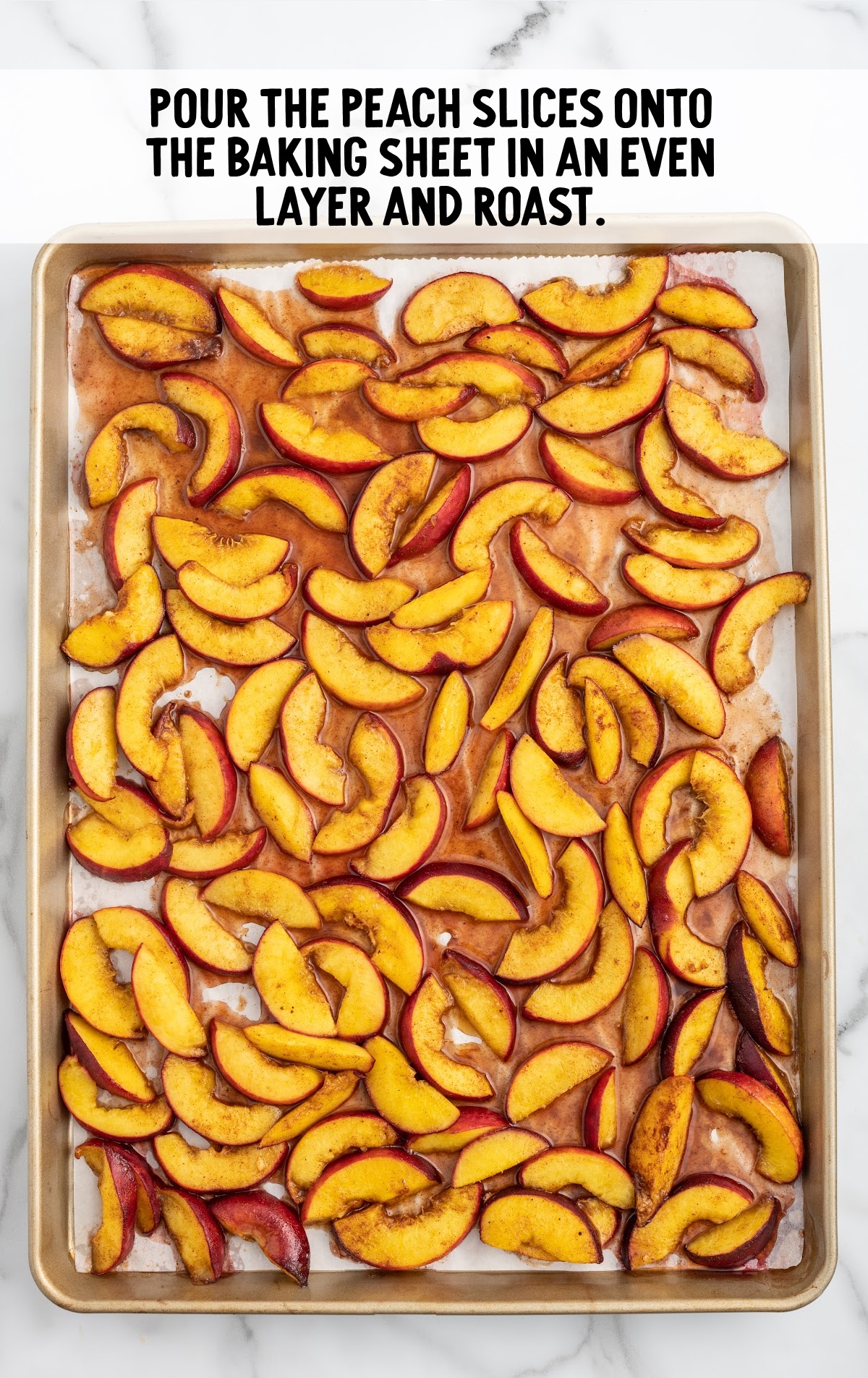 The peaches are spread evenly on a baking sheet.