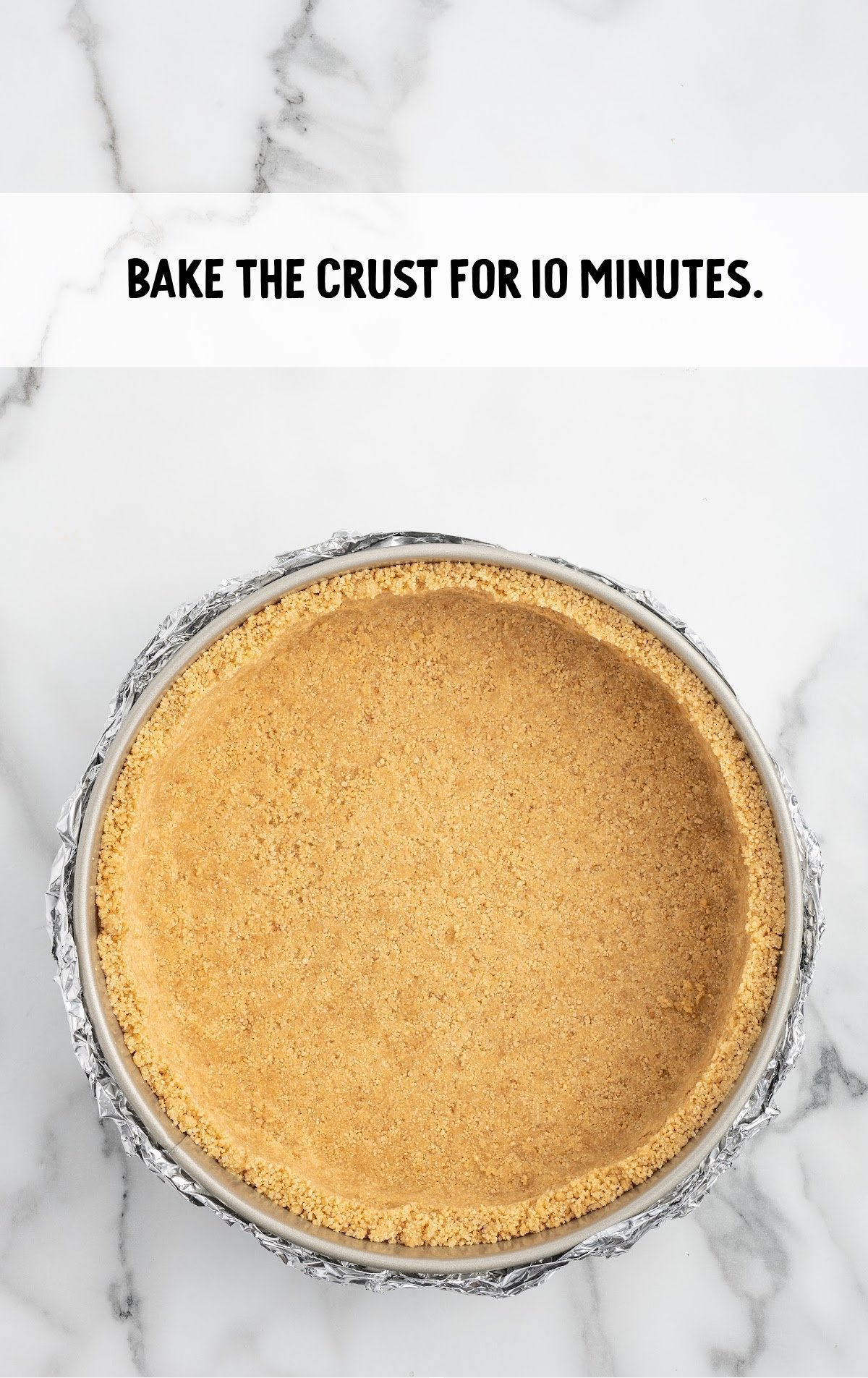 The graham cracker crust is pressed in the springform pan.