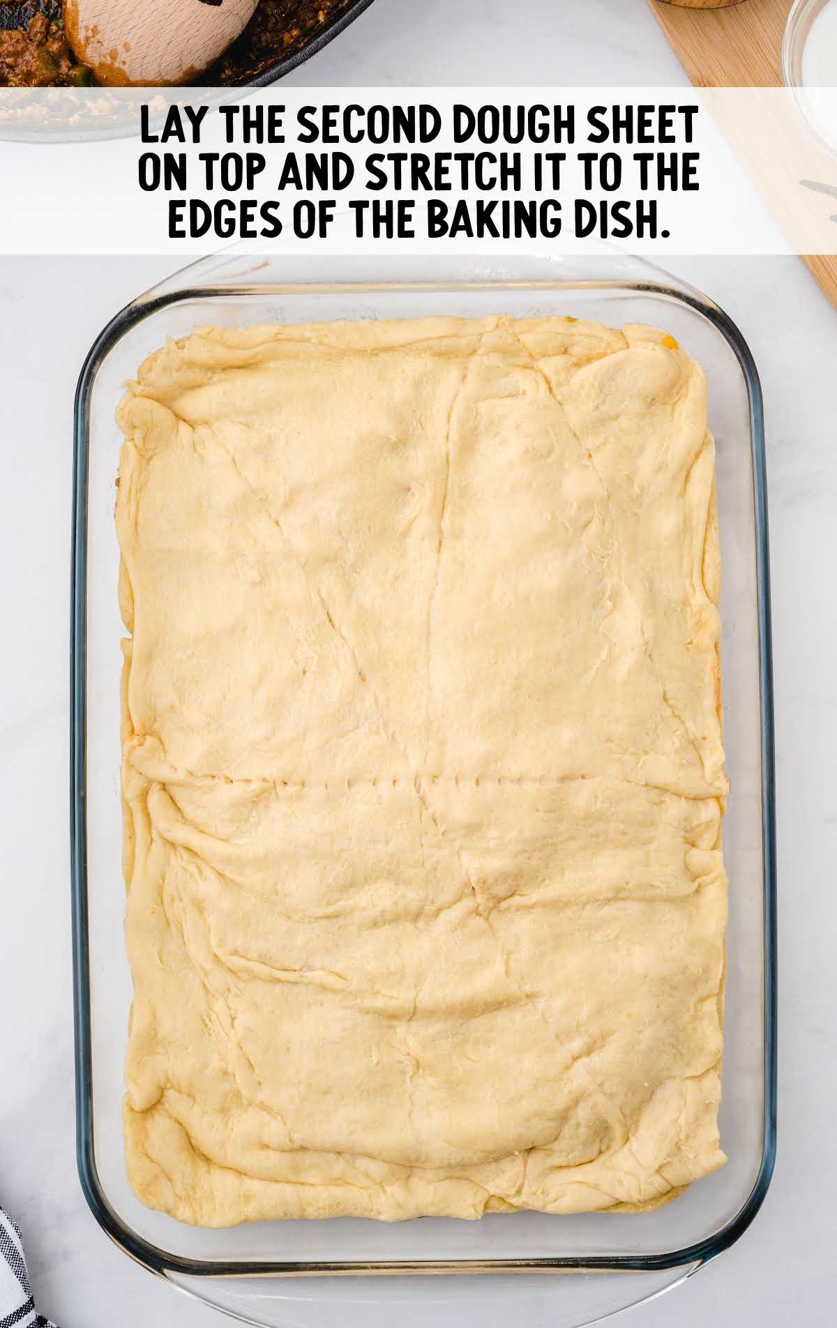 2nd layer of dough layered on top of the shredded cheese