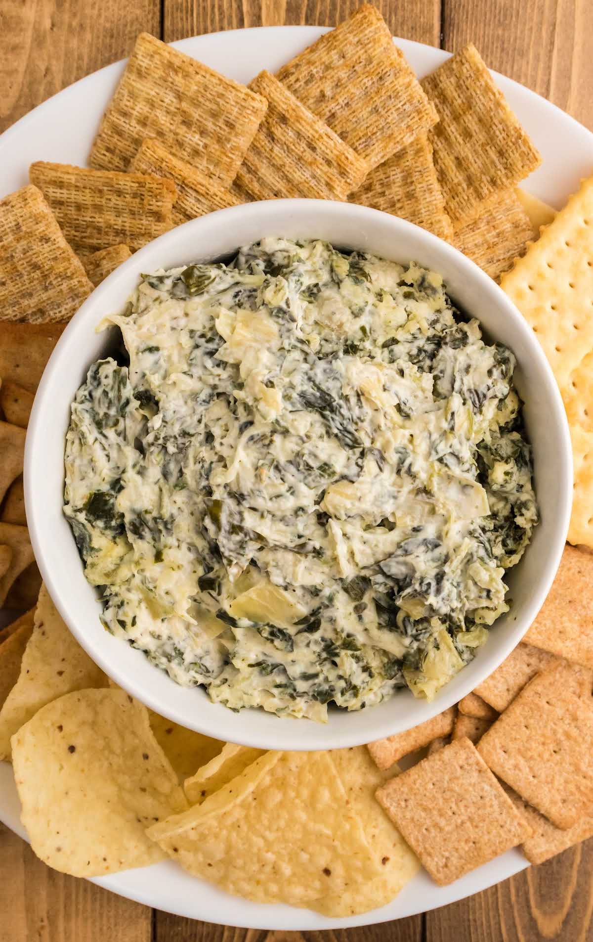 overhead shot of a bowl of dip surrounded by crackers