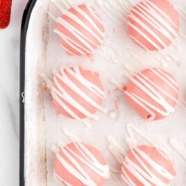 close up overhead shot of a baking sheet of strawberry cheesecake bites