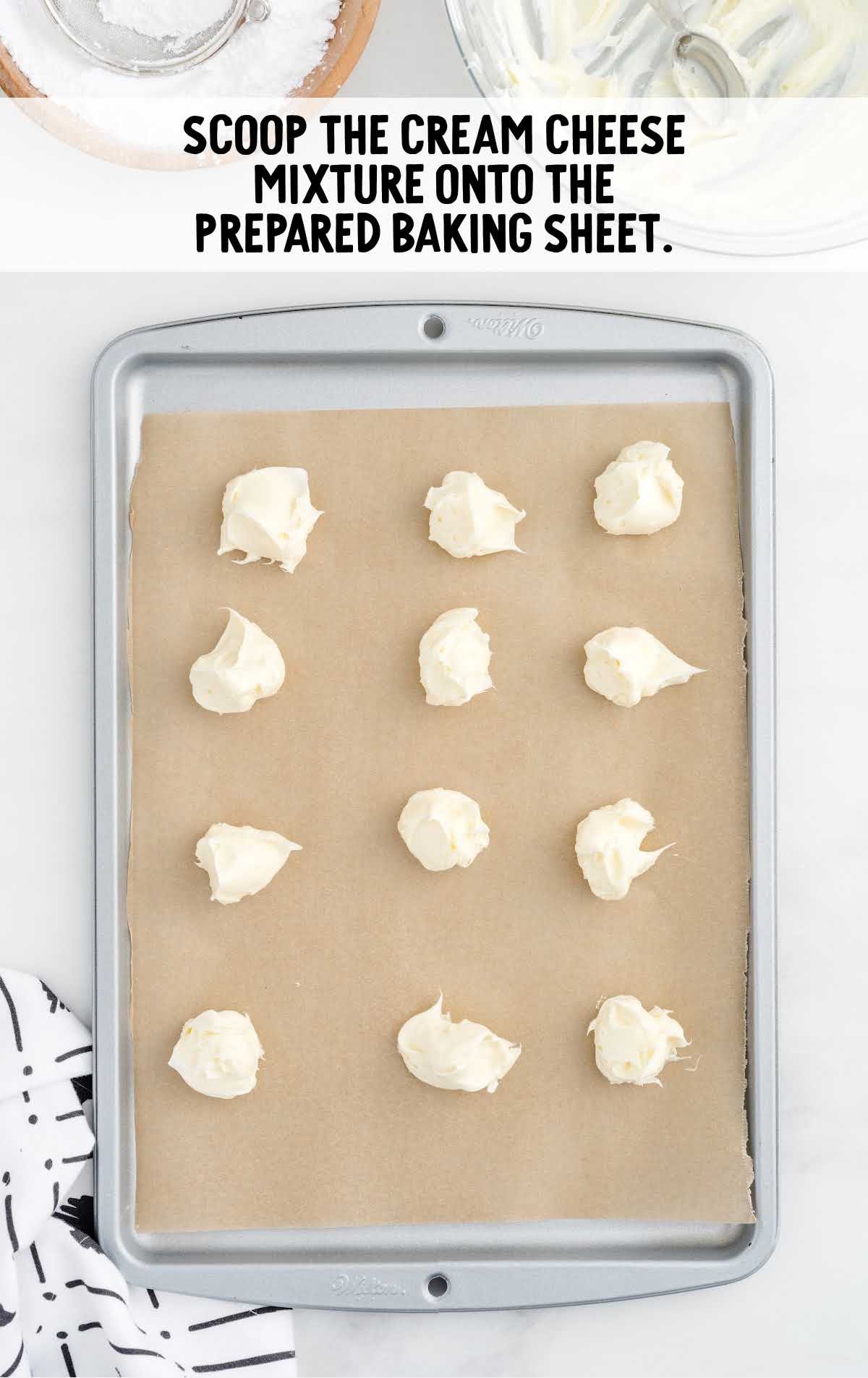 scoops of cream cheese mixture placed on a baking sheet
