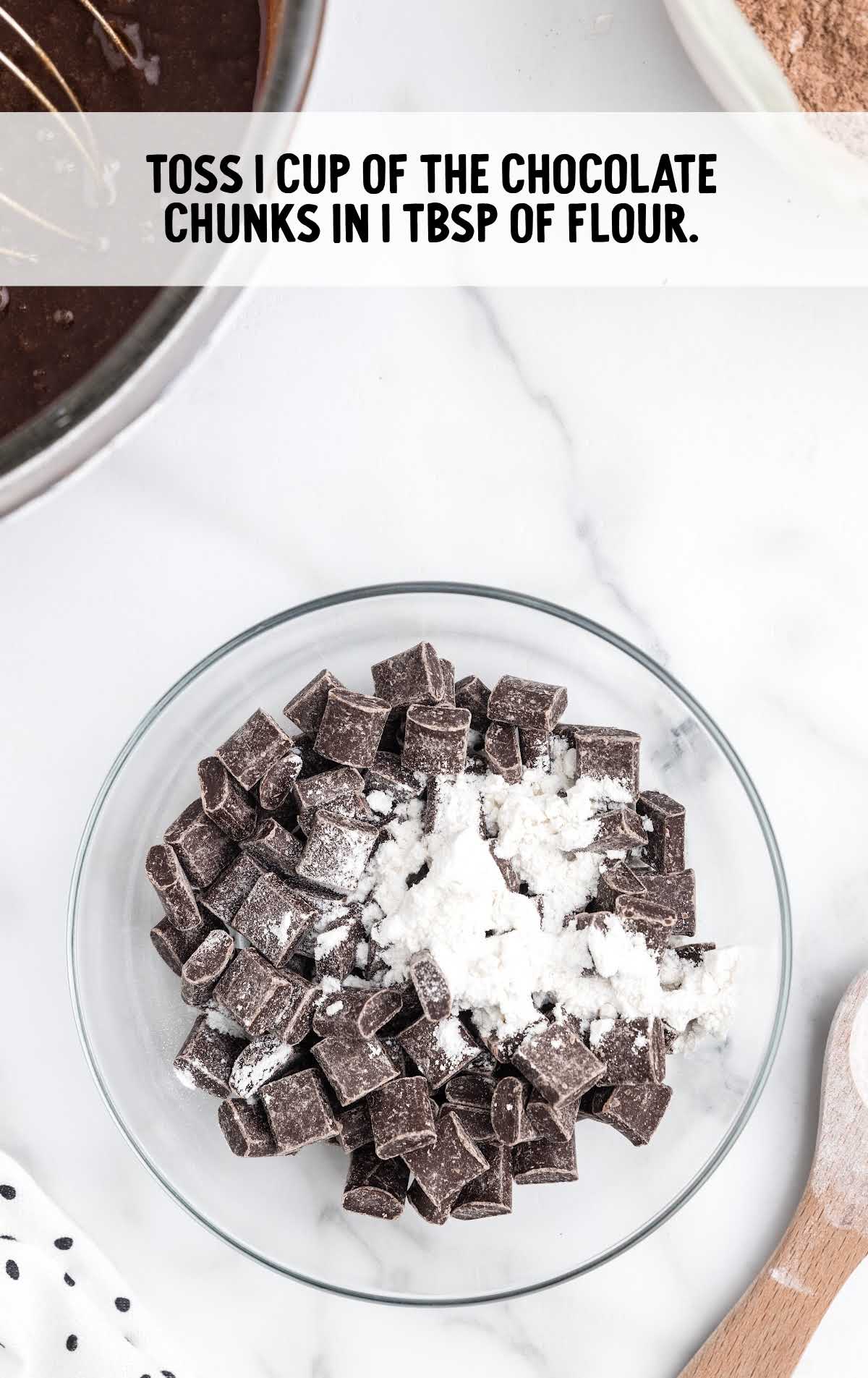 chocolate chunks and flour tossed together in a bowl
