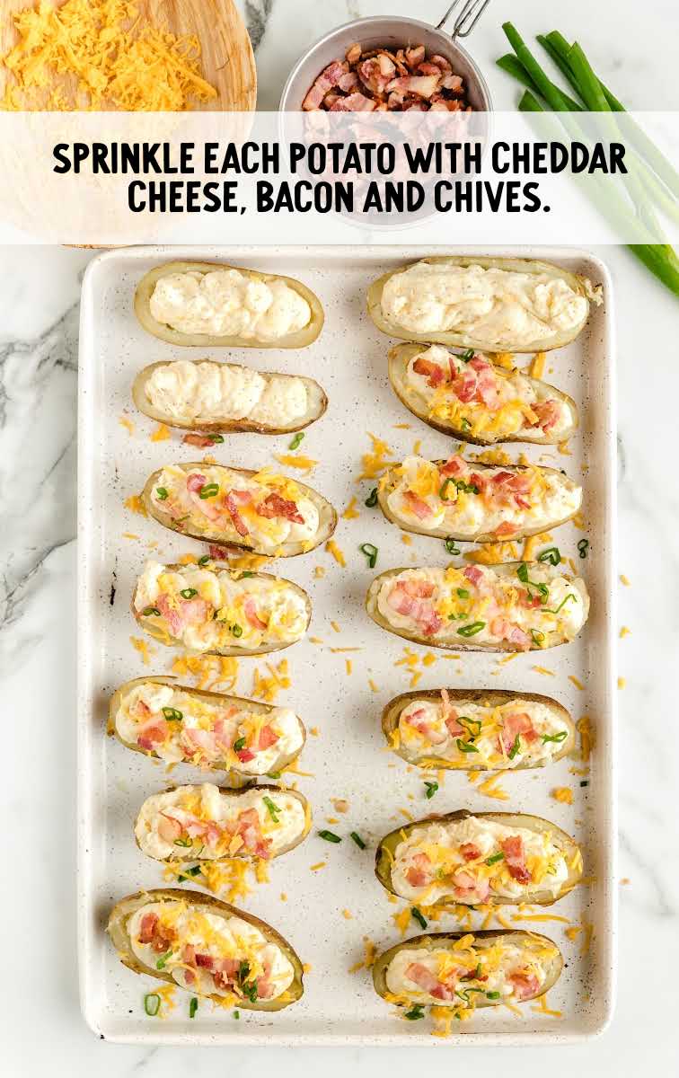 potatoes topped with cheddar cheese, bacon, and chives