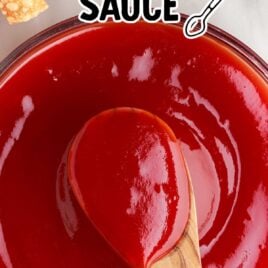 close up overhead shot of a bowl of homemade sweet and sour sauce with a spoonful of sauce