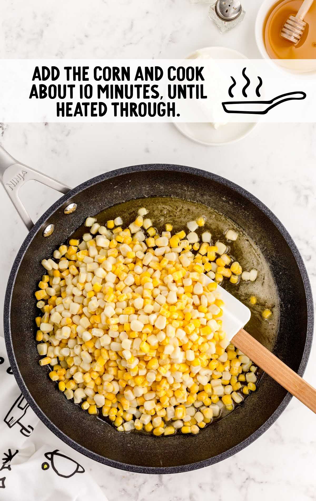corn added to the honey and butter in the skillet