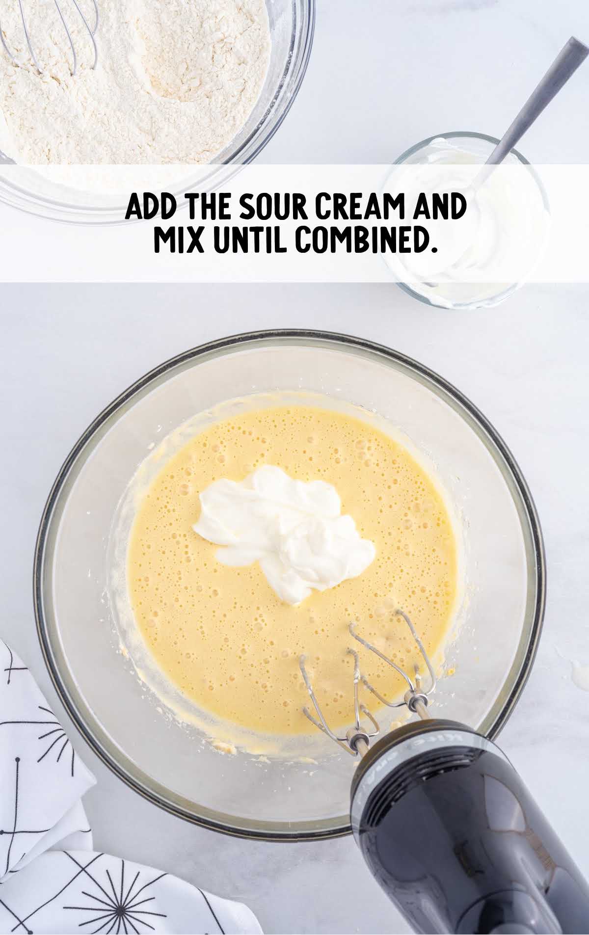 sour cream blended into the cream cheese mixture in a bowl