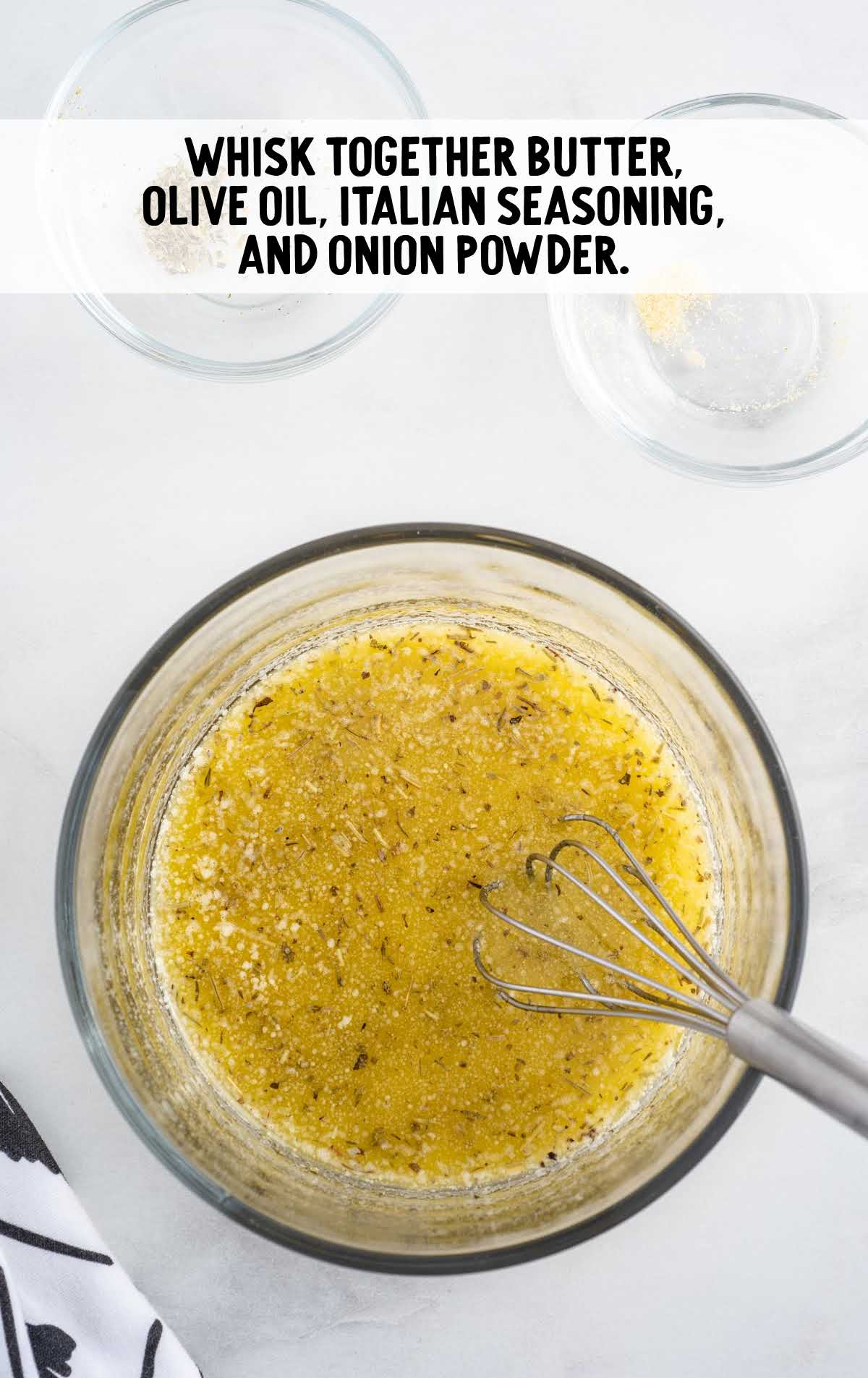butter, olive oil, and seasonings whisked together in a bowl