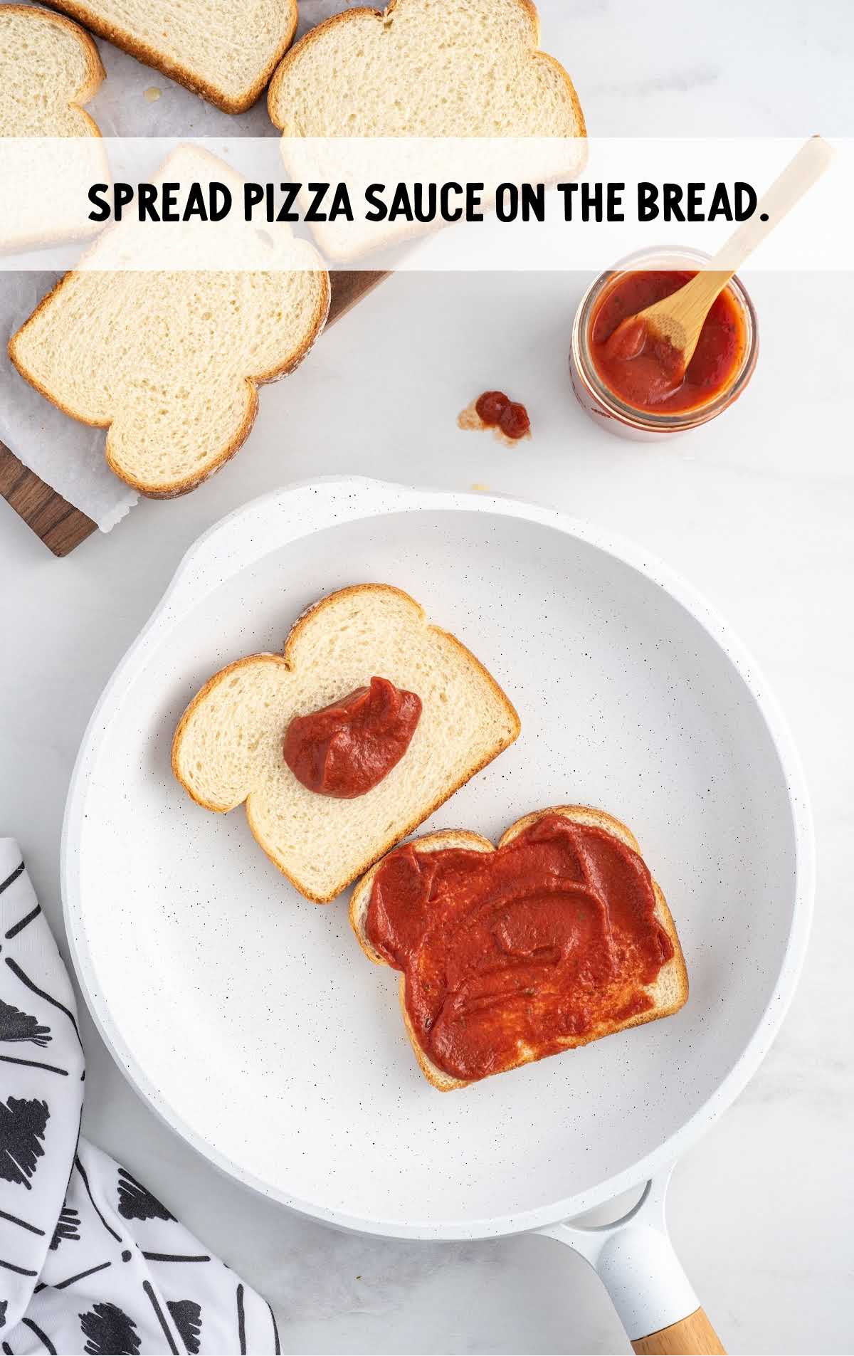 pizza sauce spread on top of the bread