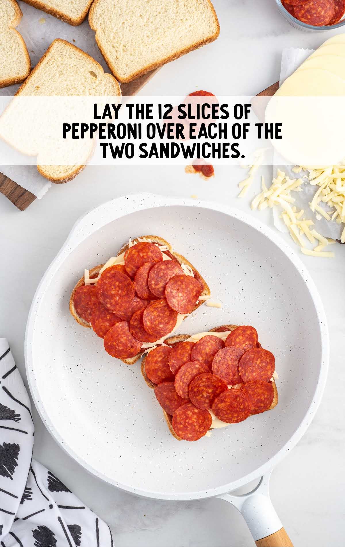 slices of pepperoni placed on top of the shredded mozzarella cheese