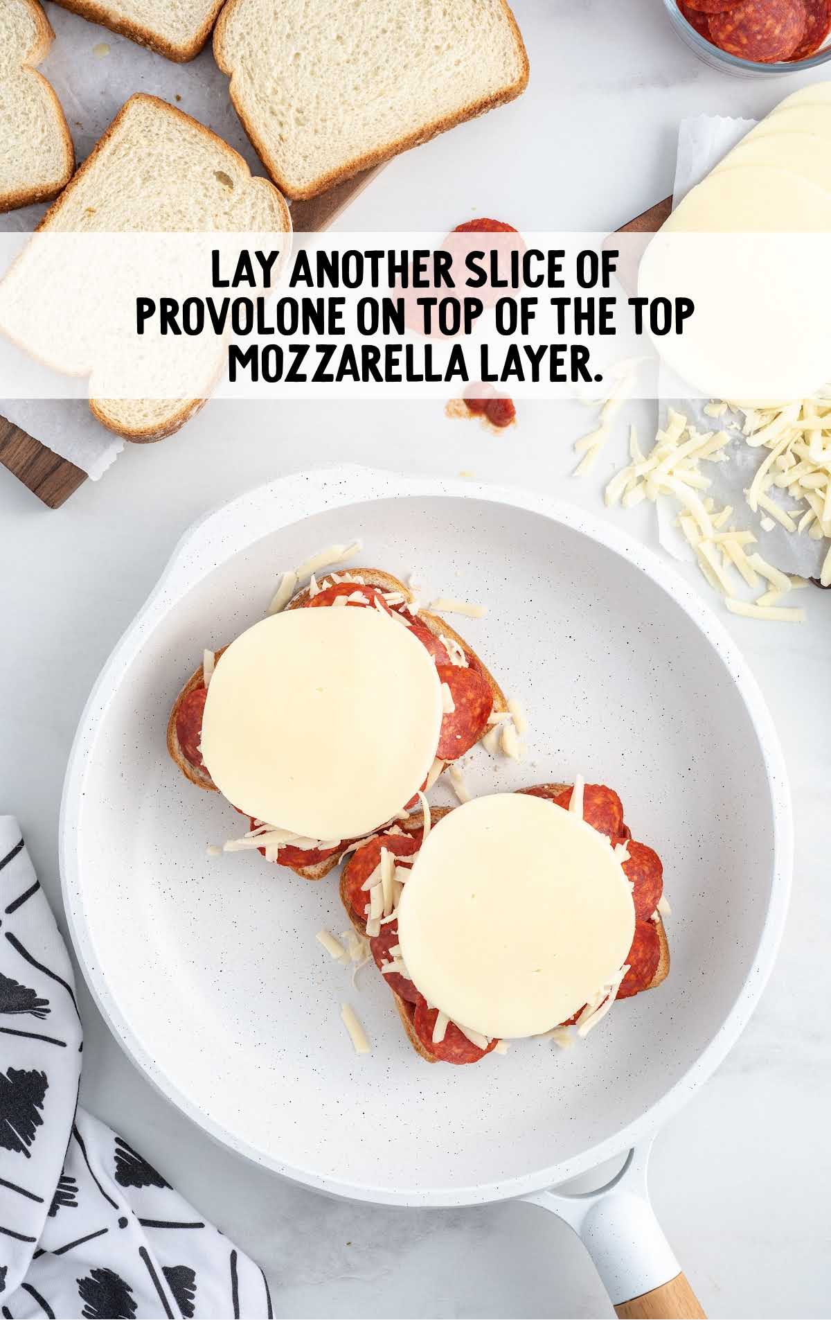 slices of provolone placed on top of the shredded mozzarella 