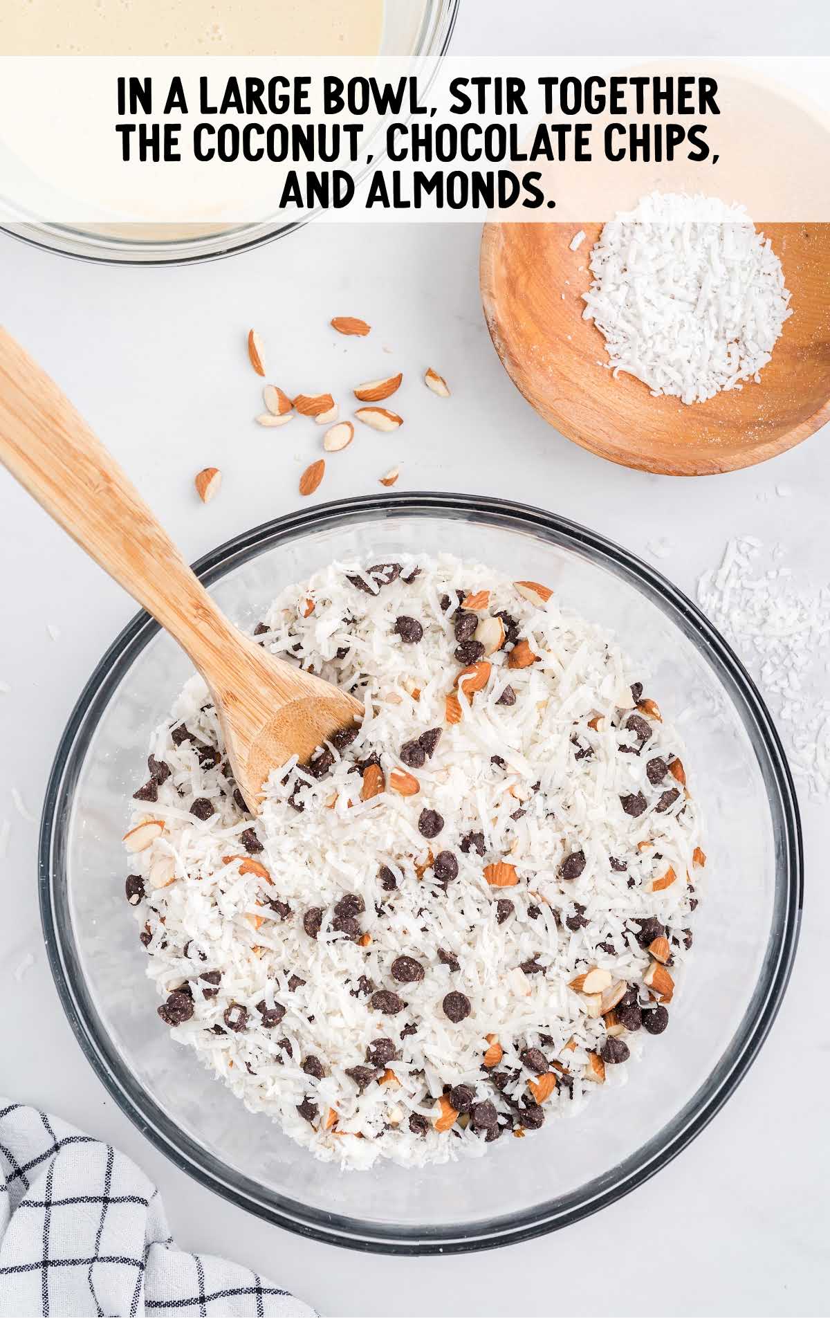 coconut, chocolate chips, and almonds folded together in a bowl