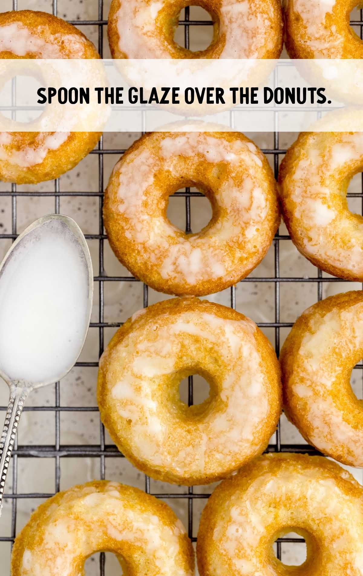 glaze spread over the top of the donuts on a cooling rack