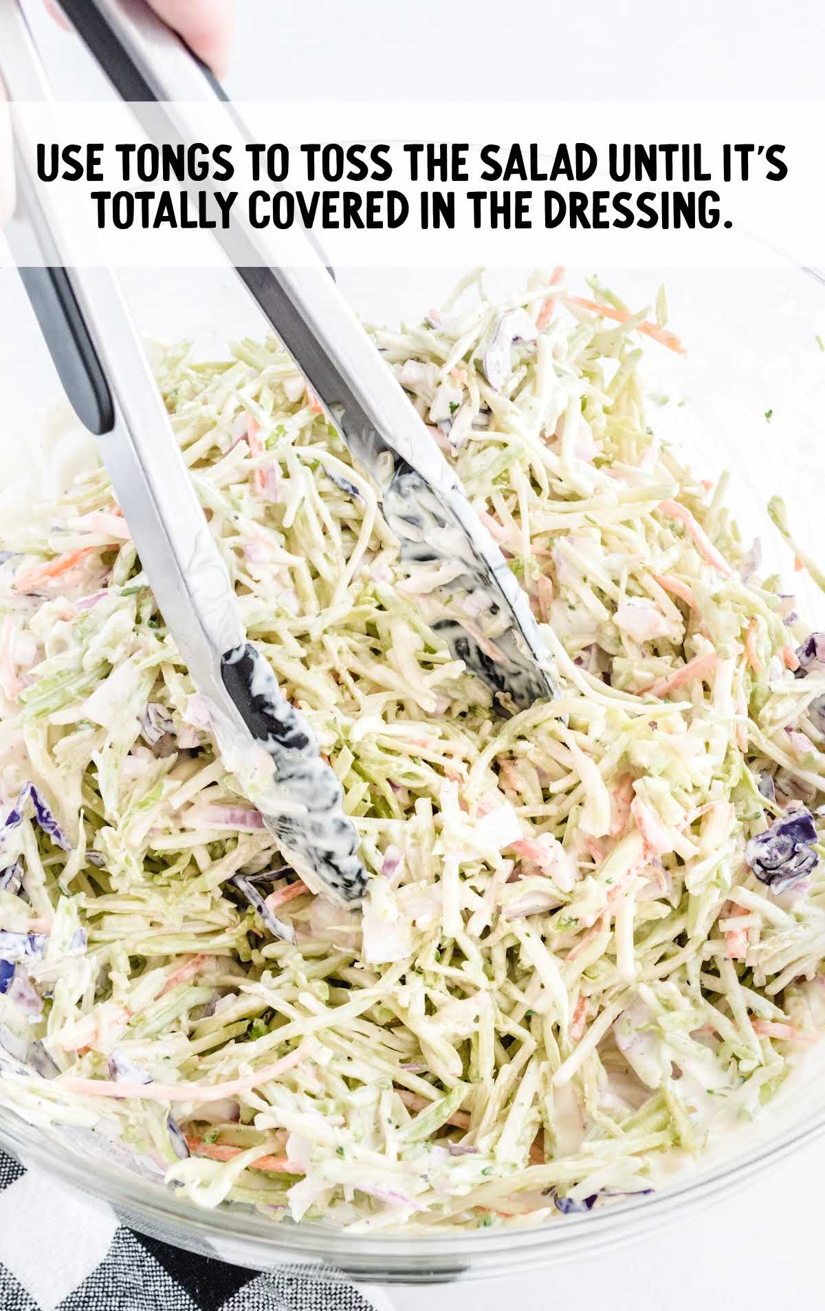 Broccoli Slaw in a bowl with tongs