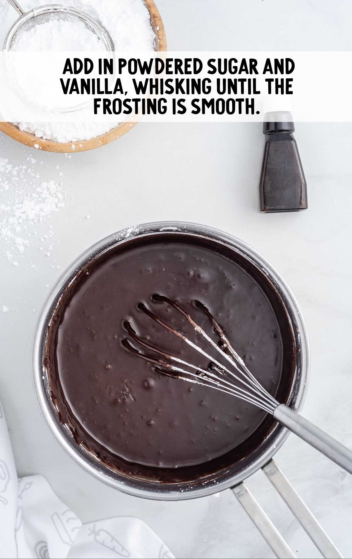 powdered sugar and vanilla whisked into a pot of frosting mixture