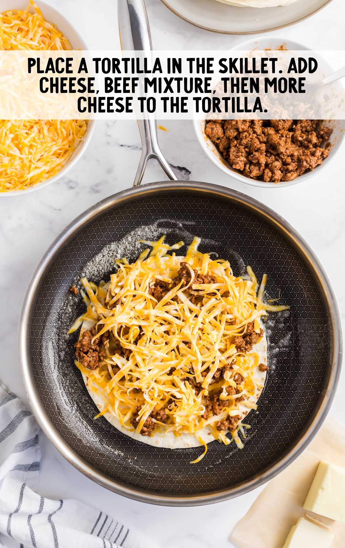 tortilla, beef mixture, and cheese added to the skillet