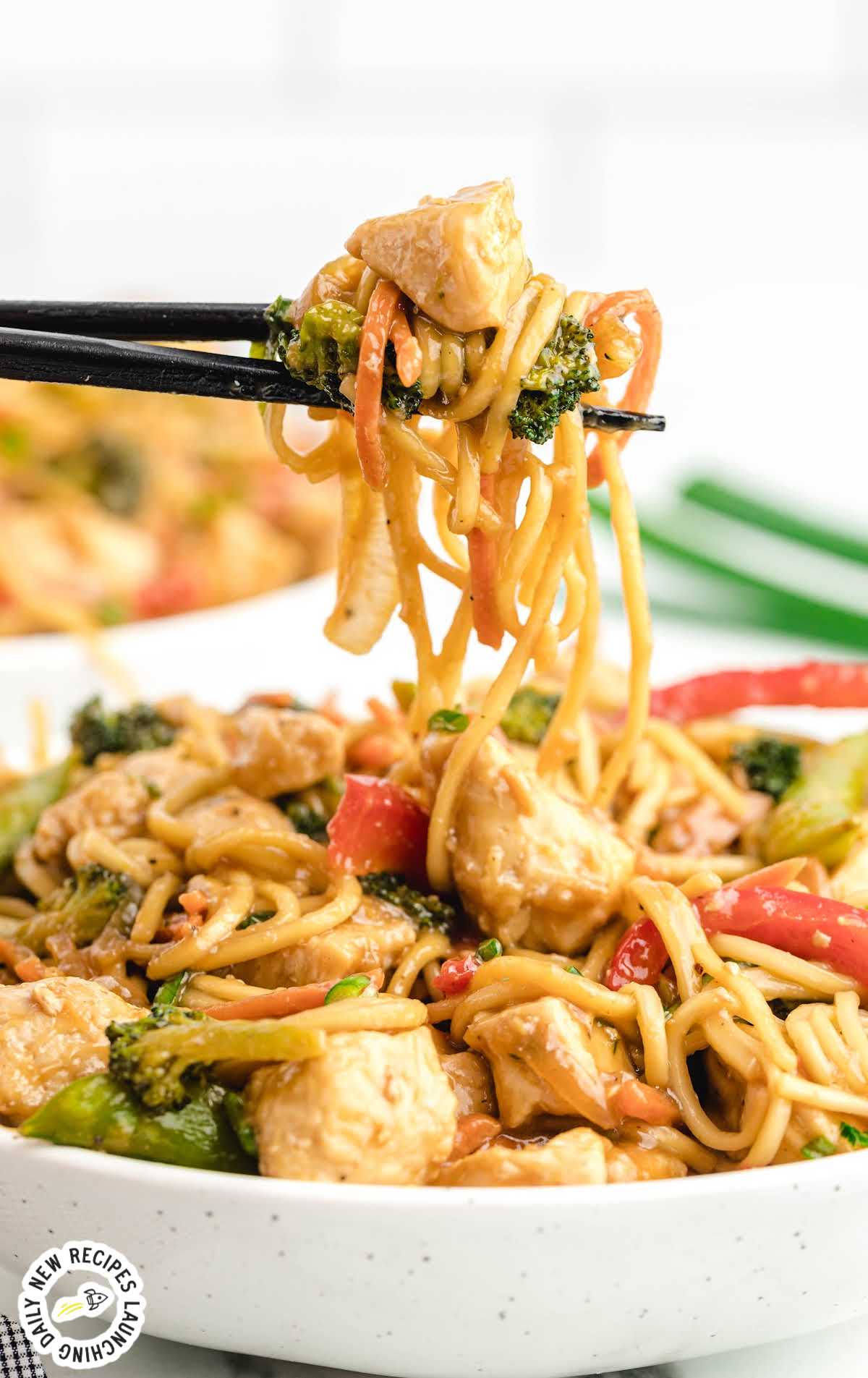 close up shot of a bowl of Chicken Lo Mein with chopsticks