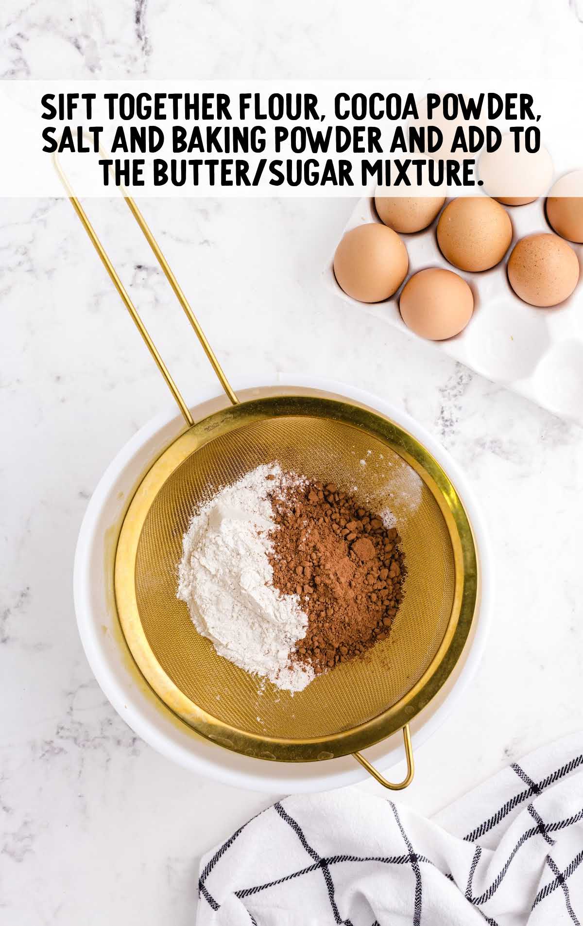 flour, cocoa powder, salt, and baking powder shifted into the butter mixture in the bowl