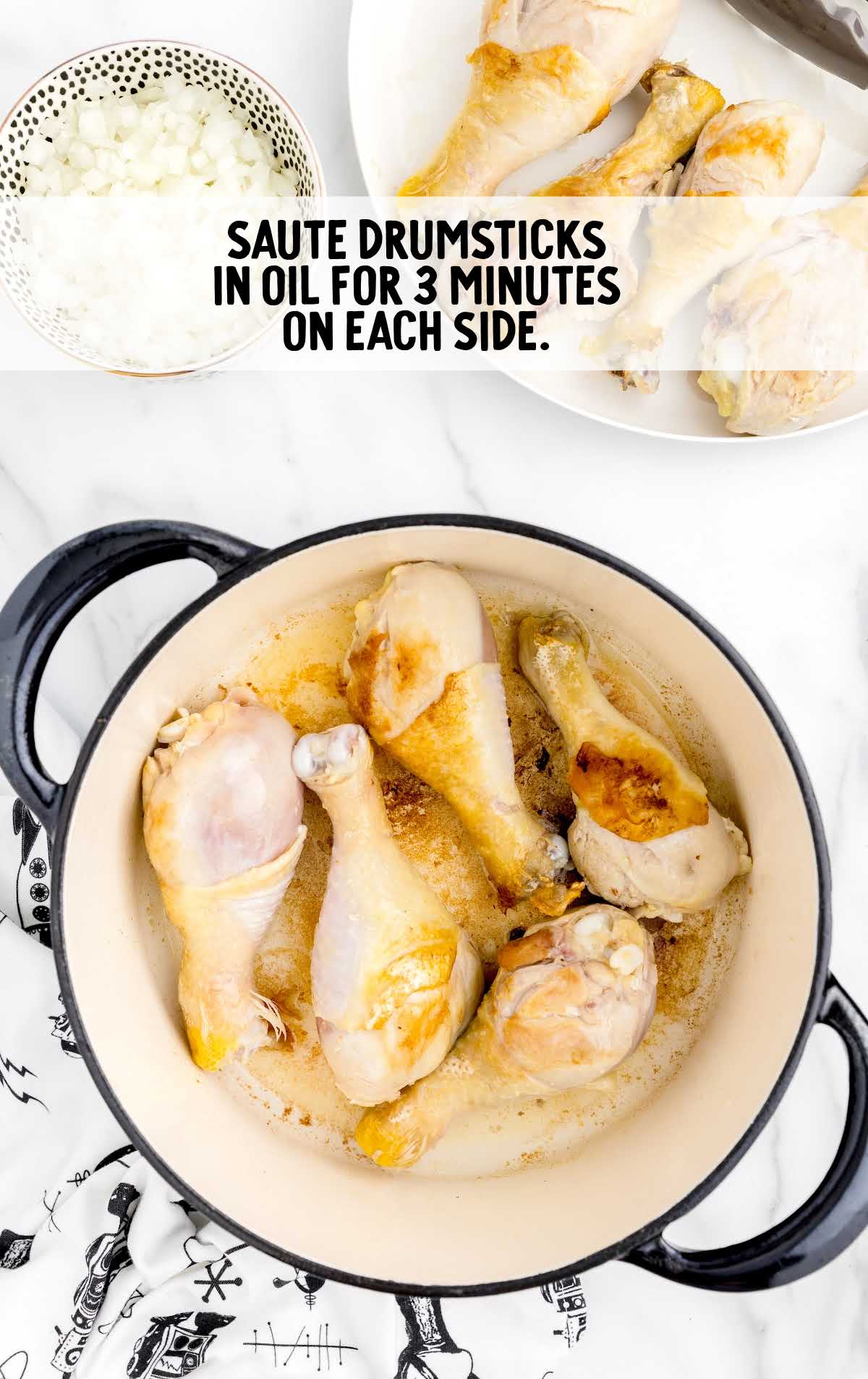chicken drumsticks being sautéed in a pot of oil