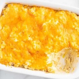 over head shot of Cracker Barrel Hashbrown Casserole in a baking dish with a piece missing