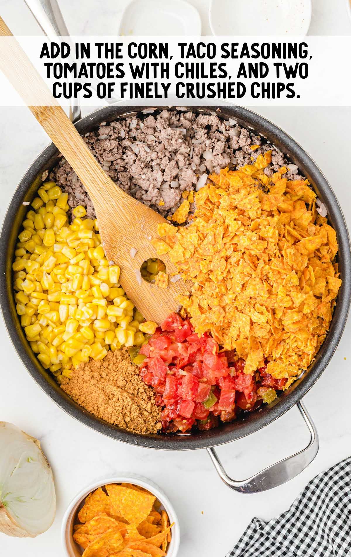 corn, taco seasoning, tomatoes, and chips added to the ground beef mixture in the skillet