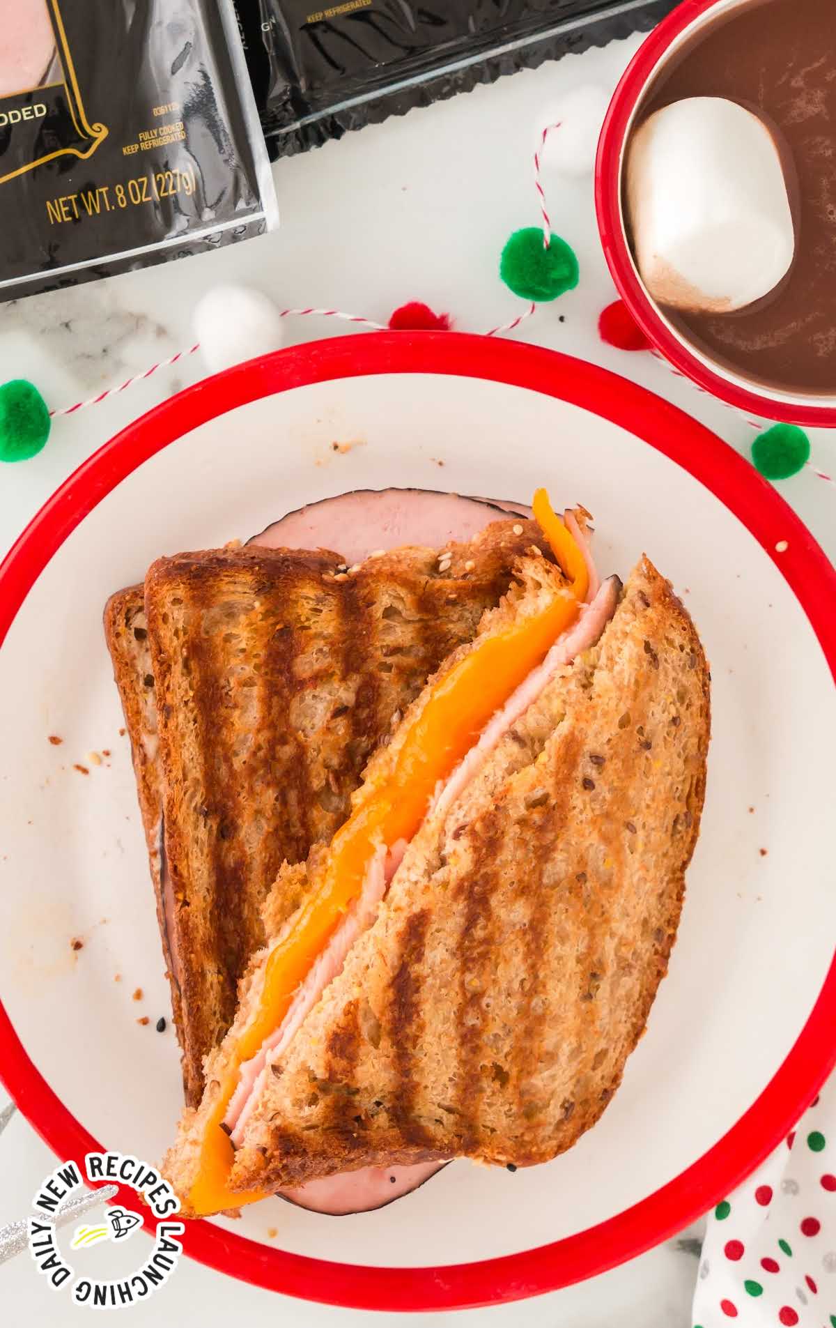 close up overhead shot of slices of a Grilled Ham and Cheese sandwich on a plate