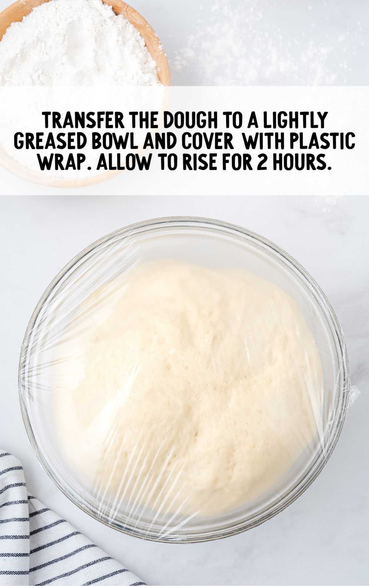 dough in a bowl wrapped in plastic