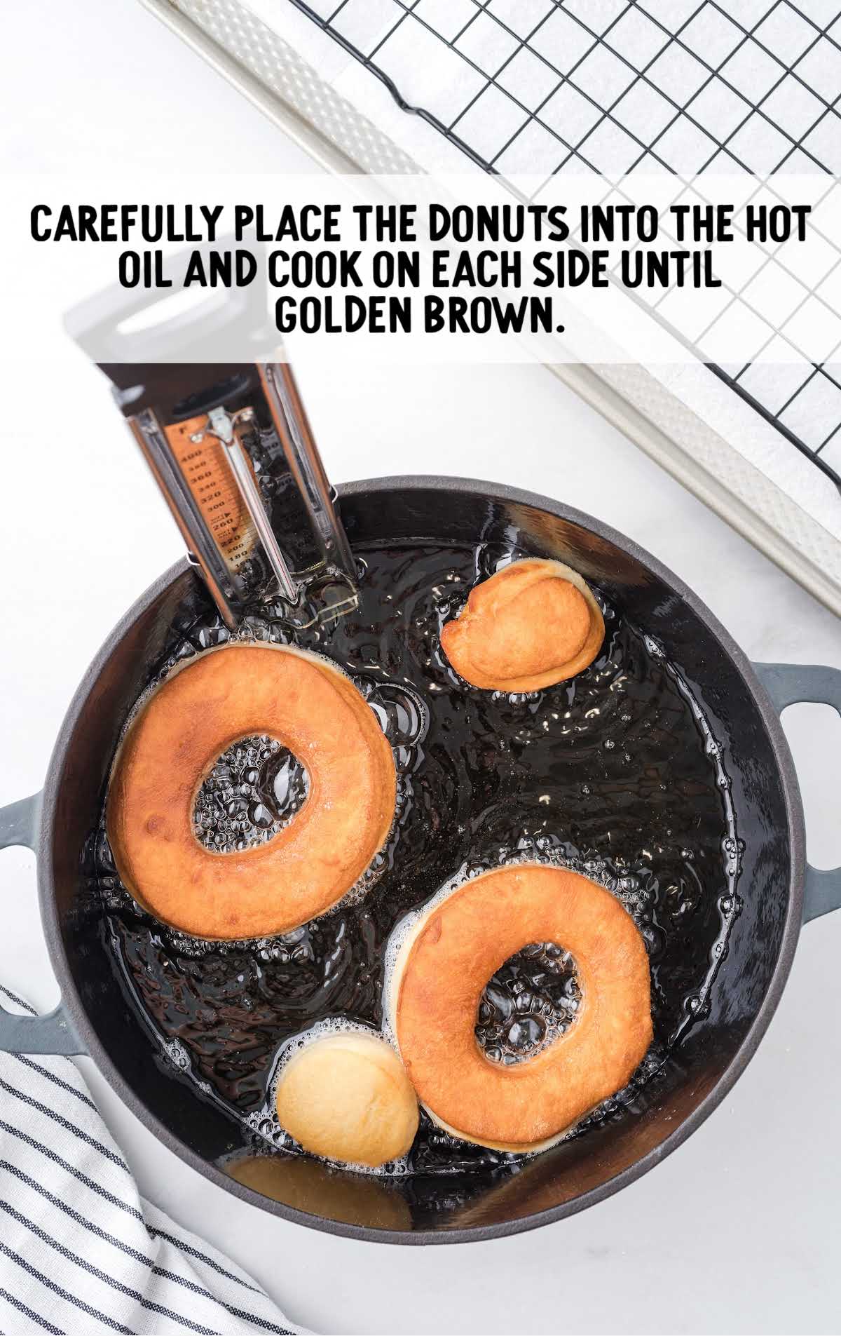 donuts in hot oil in a cooking pot