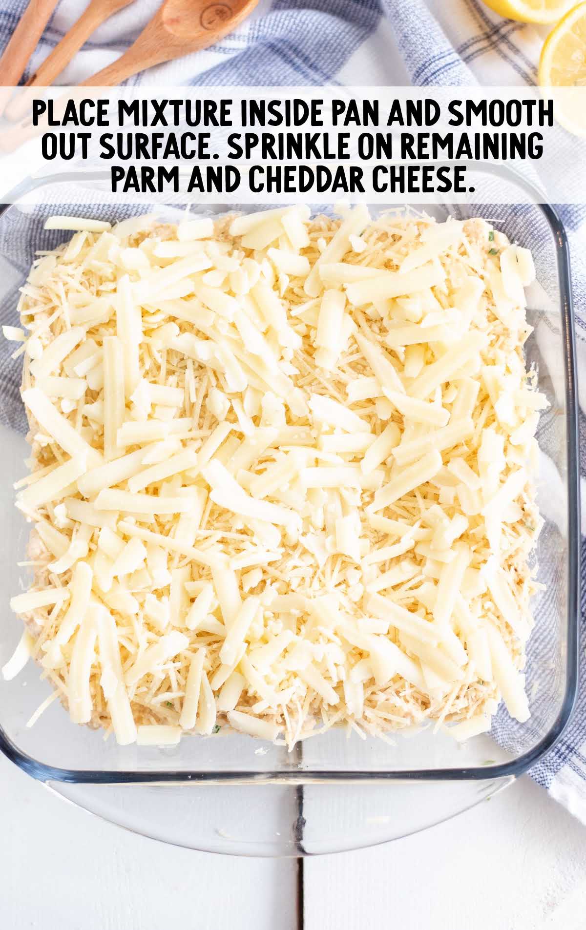 crab dip mixture spread into a baking dish then topped with cheeses