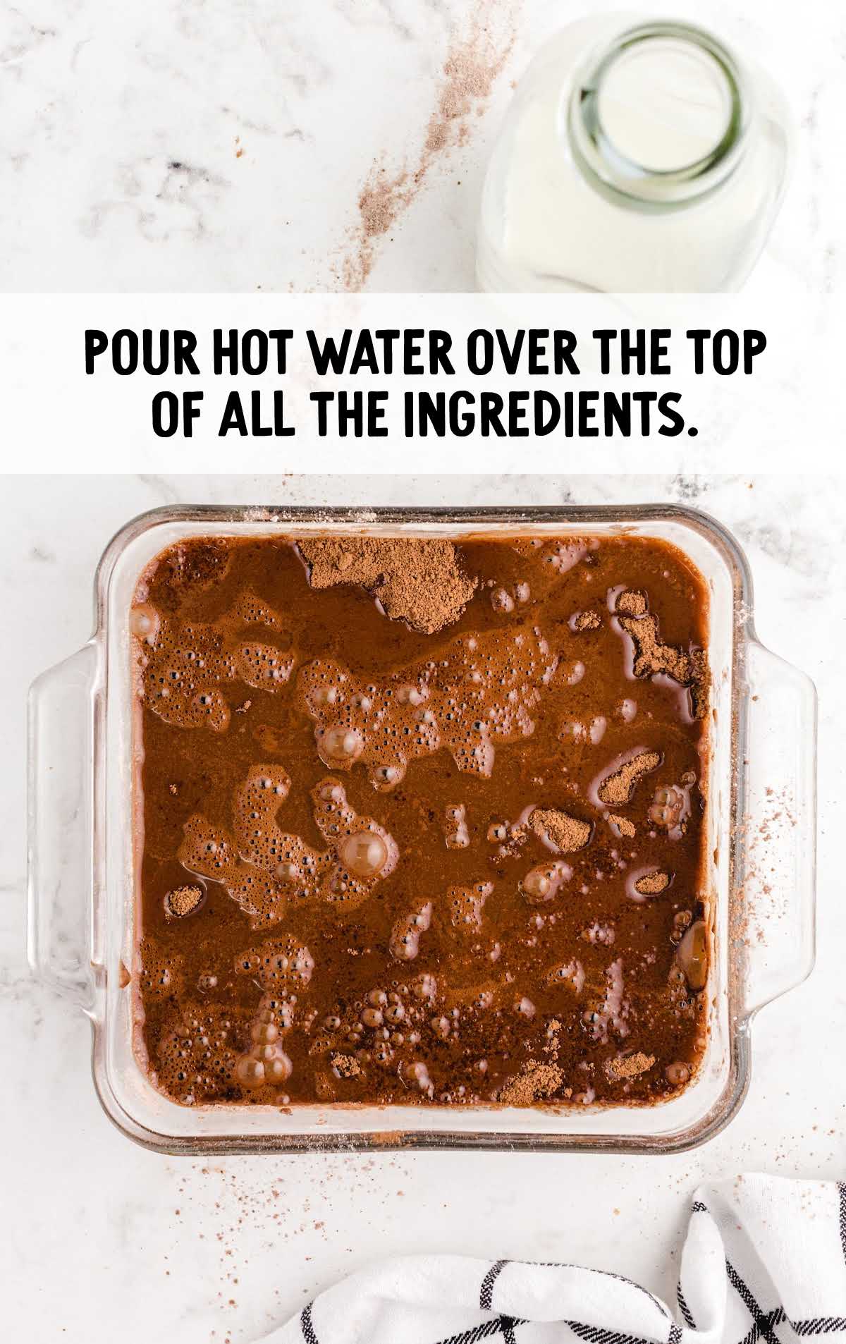 hot water poured on top of the ingredients in the baking dish