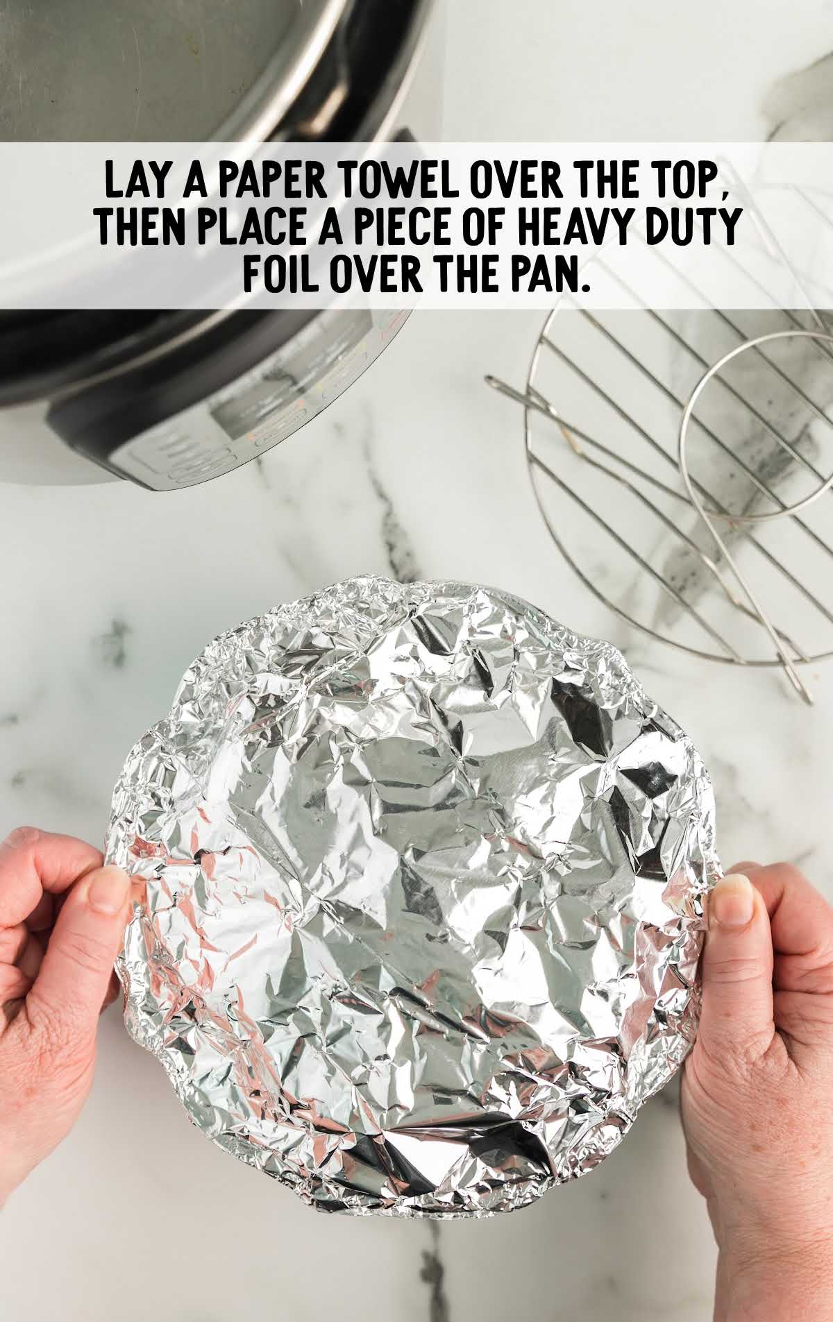 a piece of foil placed on top of the bundt pan