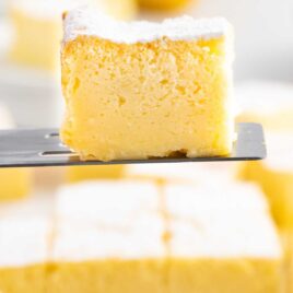 close up shot of a slice of Lemon Custard Cake on a spatula