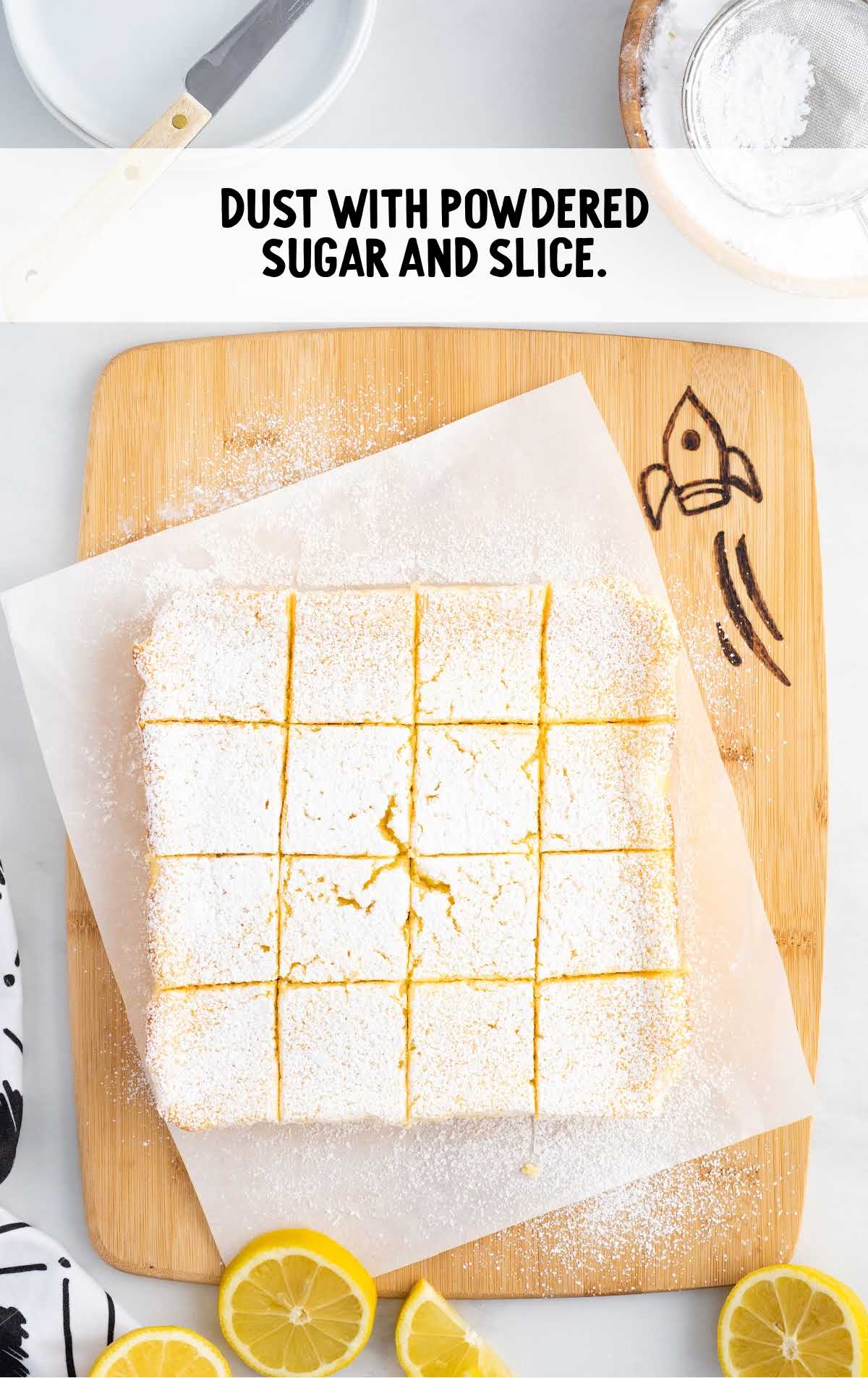 slices of Lemon Custard Cake on a parchment sheet dusted with powdered sugar