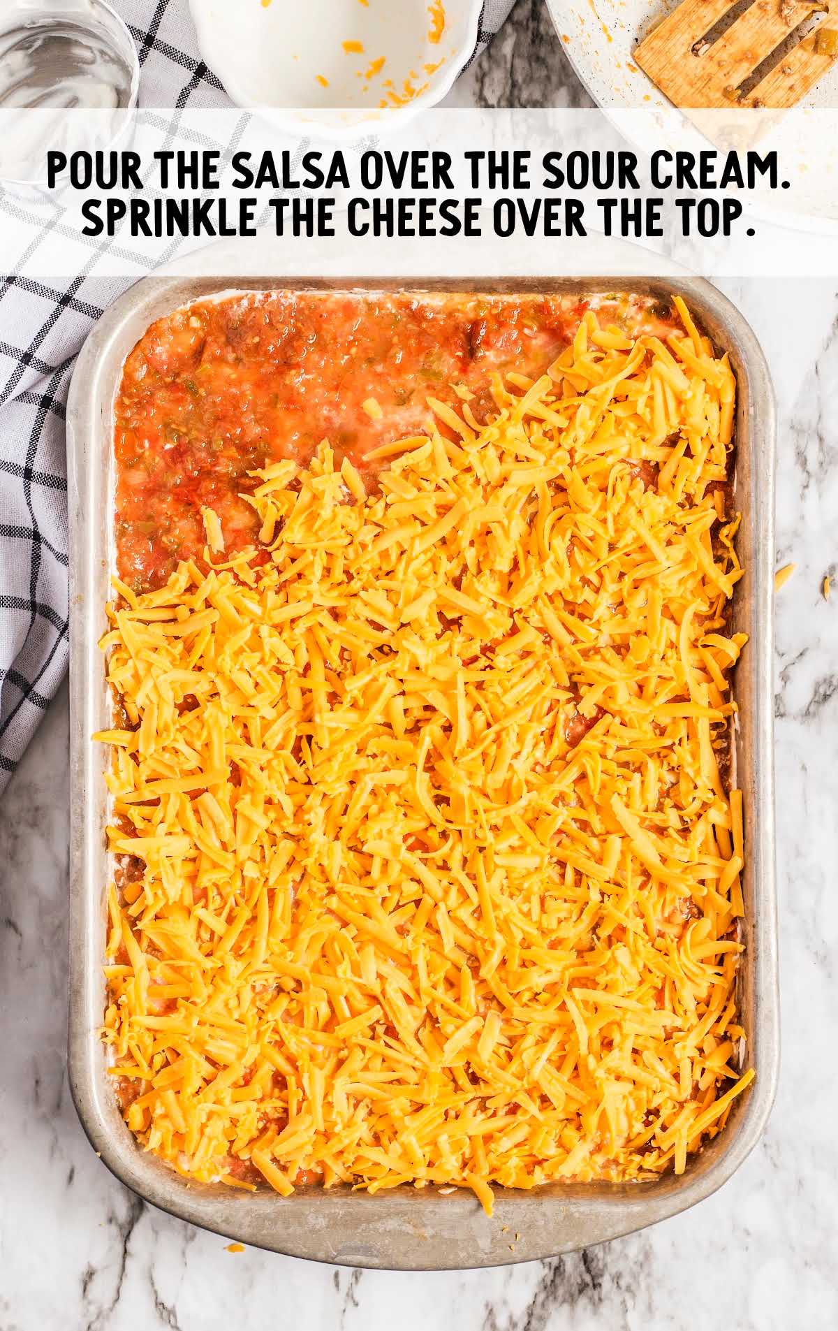 salsa poured over the sour cream then topped with shredded cheese