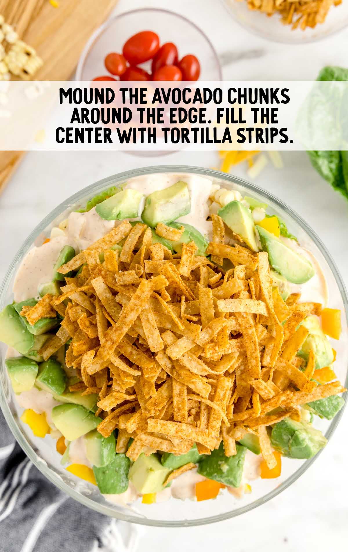 salad topped with avocado and tortilla strips