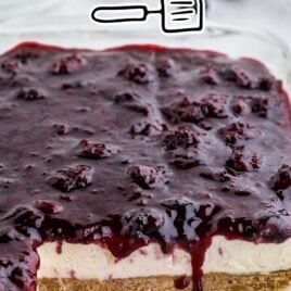 close up shot of blackberry cheesecake in a baking dish with slice missing
