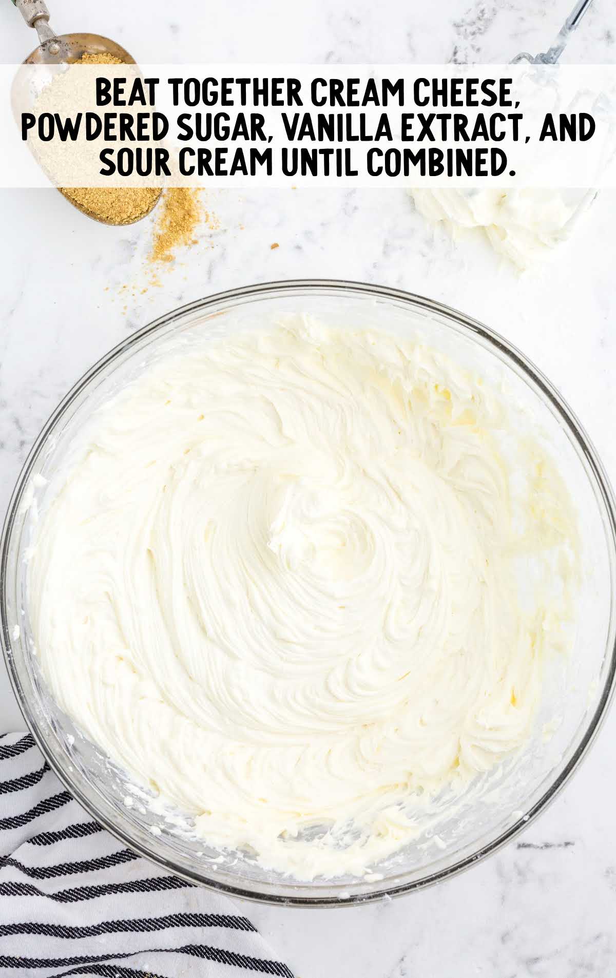 cream cheese, sugar, vanilla, and sour cream combined in a bowl