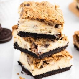pieces of Oreo Chocolate Chip Cheesecake Cookie Bars stacked on top of each other