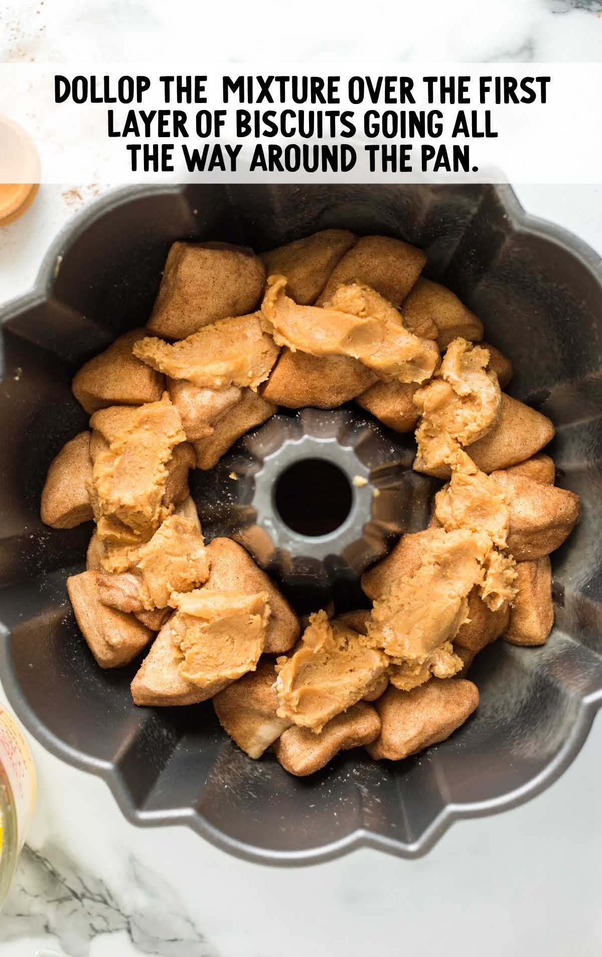 peanut butter mixture placed on top of the biscuits in the bundt pan