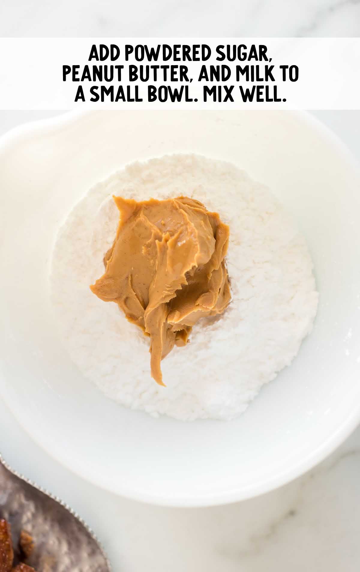 powdered sugar, peanut butter, and milk in a bowl