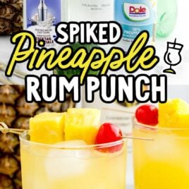 close up shot of a glass of Pineapple Rum Punch garnished with pineapples and a cherry