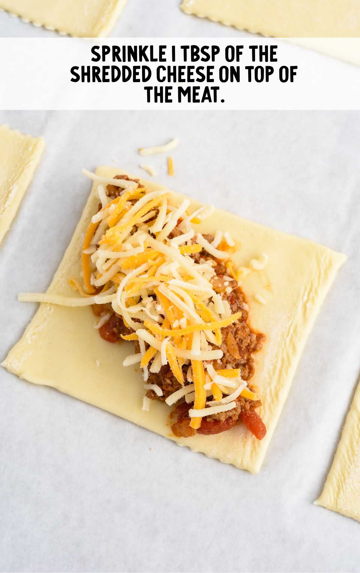shredded cheese sprinkled on top of the meat