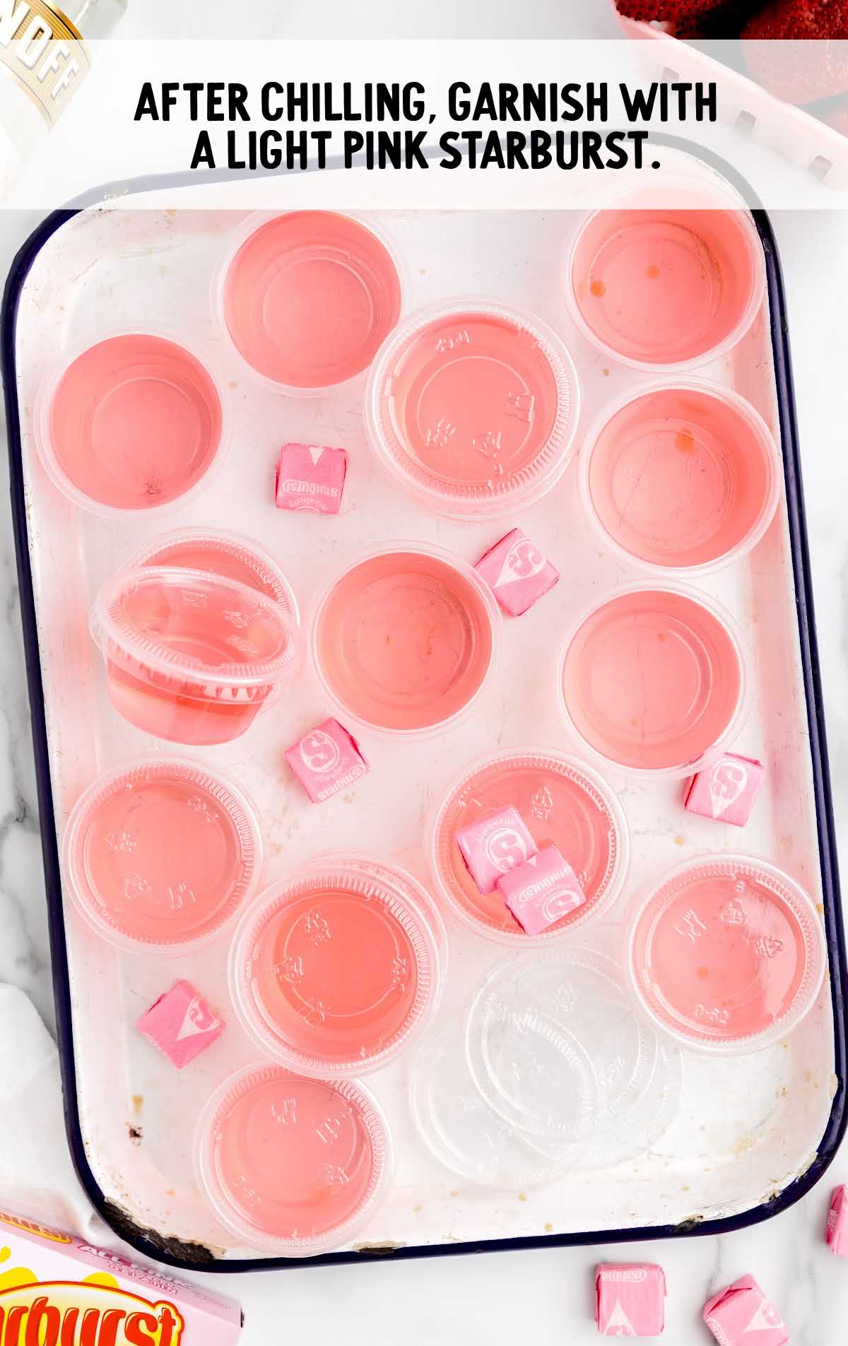 pink starburst garnished in the jello on a baking dish