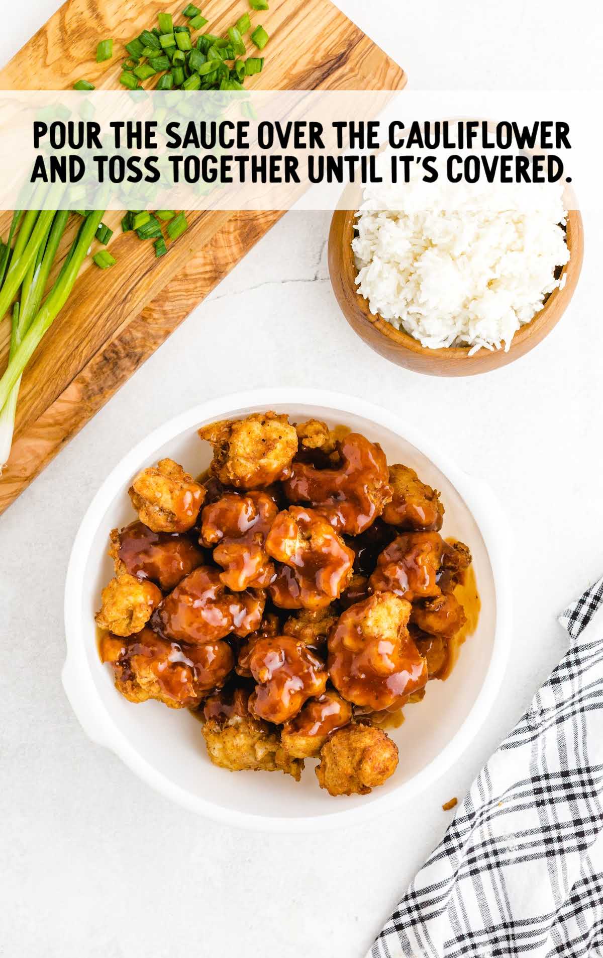 sauce poured on top of fried cauliflower in a bowl