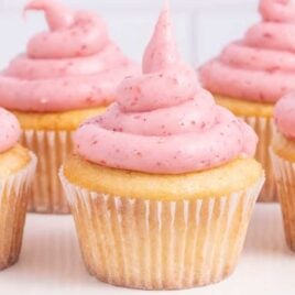 a close up shot of cupcakes topped with Strawberry Cream Cheese Frosting
