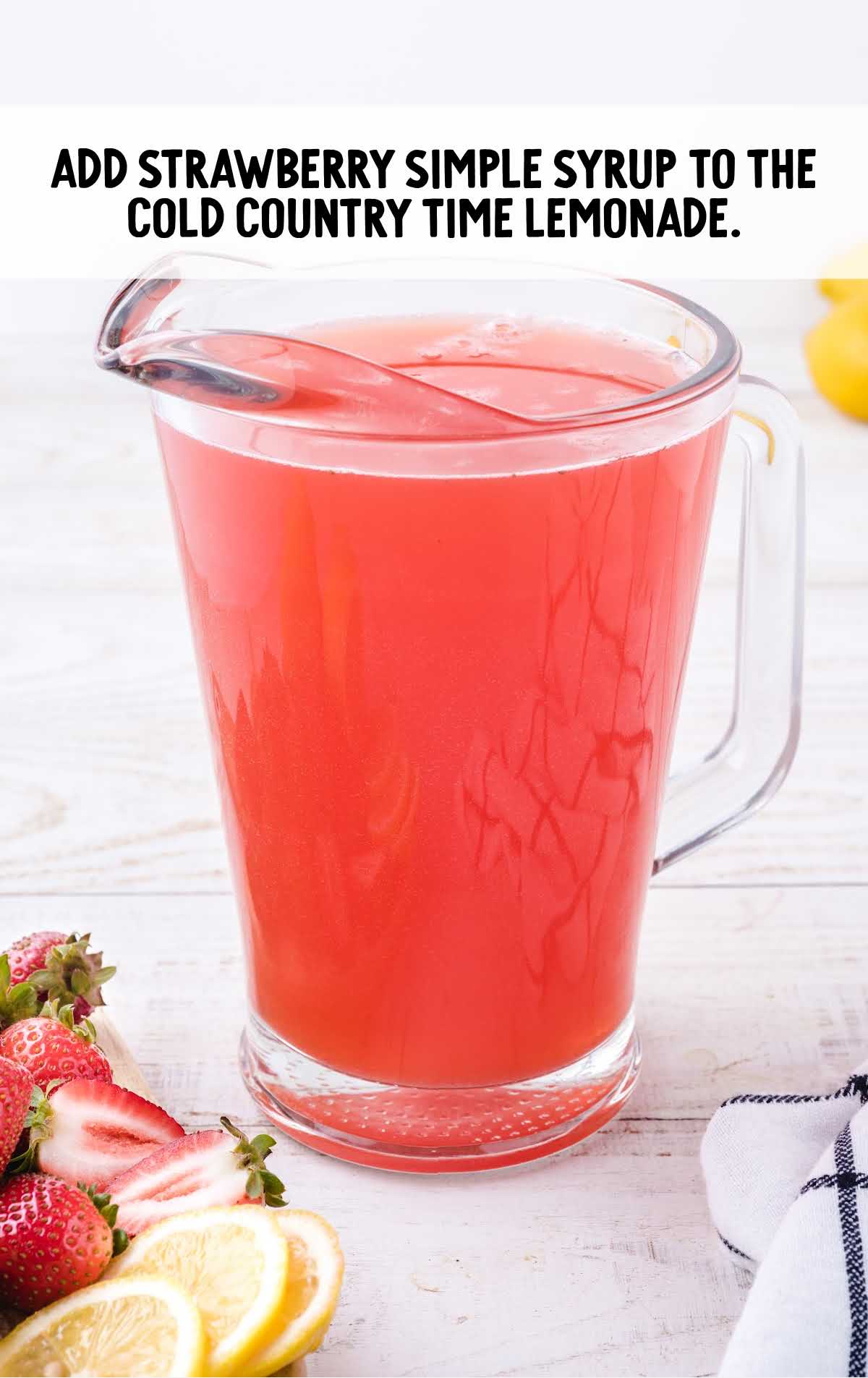 strawberry simple syrup added to the pitcher of lemonade