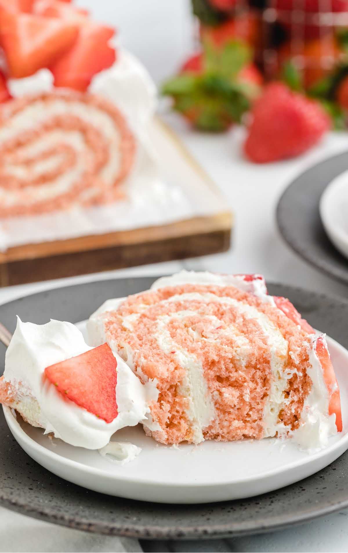 a slice of strawberry roll cake on a plate